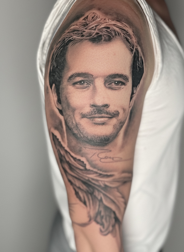 Black & Grey Tattoo eines jungen Mannes auf dem Arm
